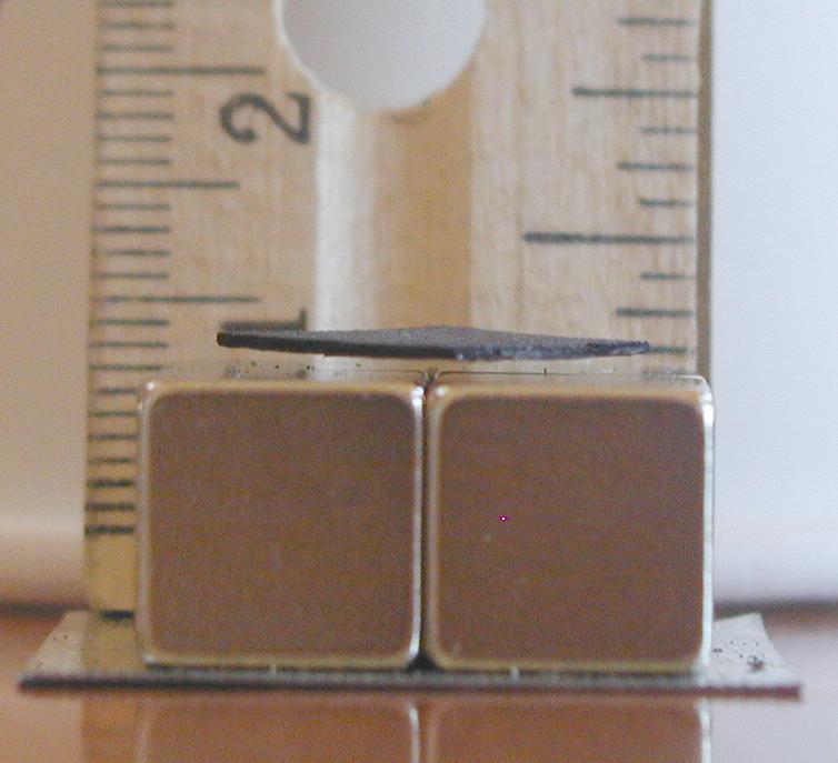 Levitating pyrolytic graphite next to a ruler